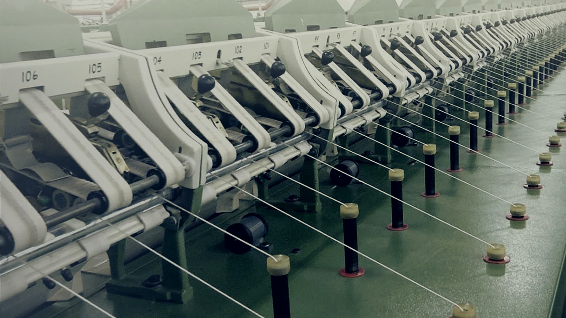A row of spinning frames drawing yarn
